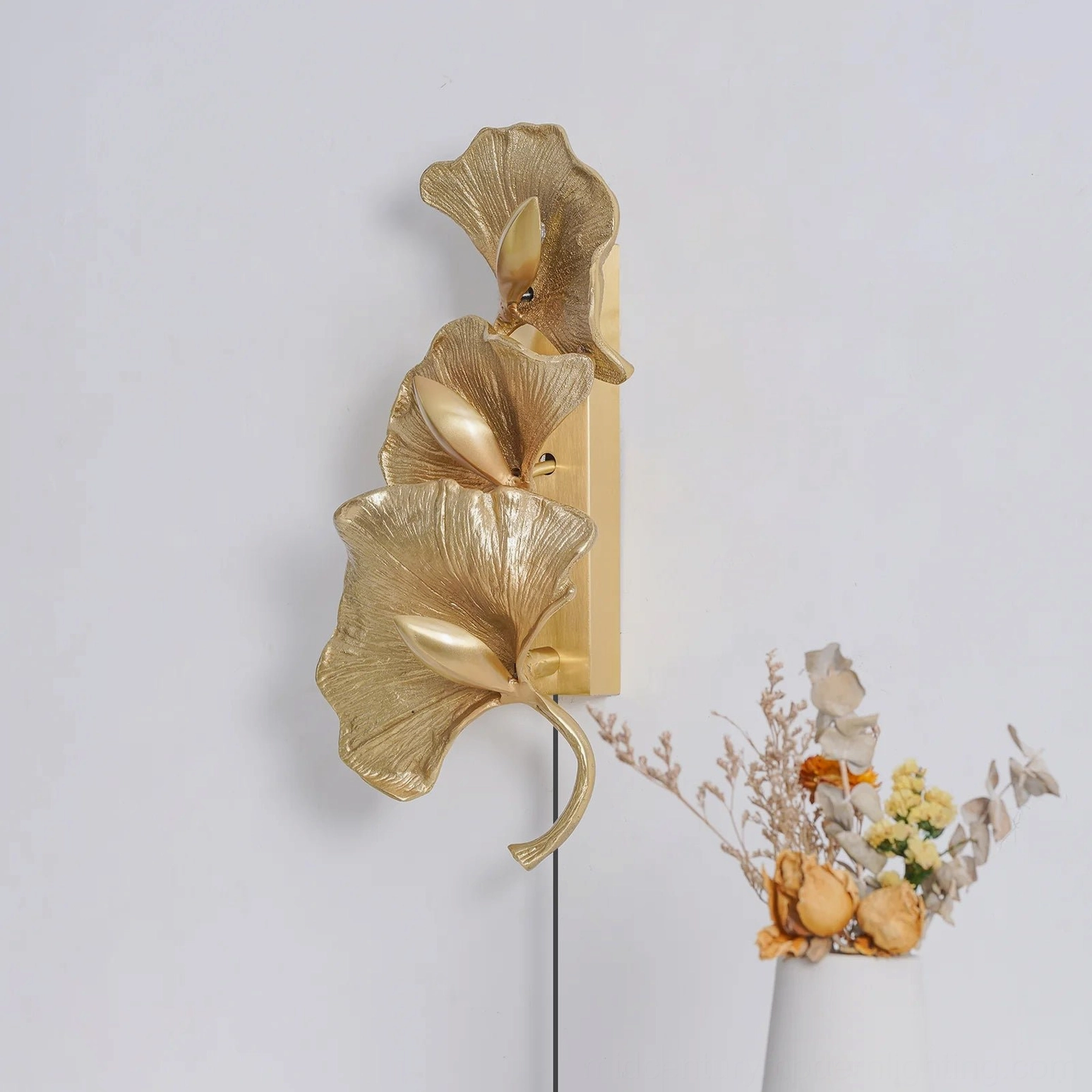 Rear sculptural view of brass ginkgo leaf wall lamp showing leaf vein detailing and mounting structure