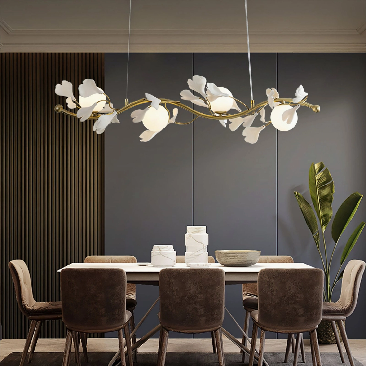 Ginkko Glass Chandelier in contemporary dining space with dark panel walls, brown dining chairs, and green potted plant