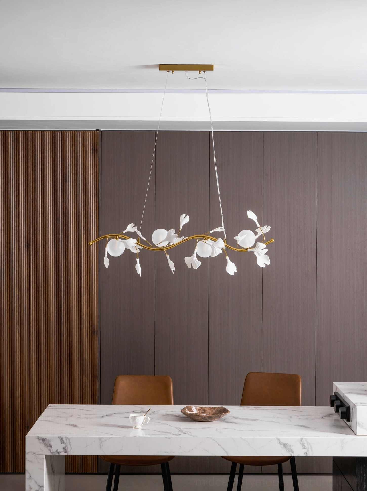 Ginkko Glass Chandelier mounted above dining table showing scale and proportion in interior space