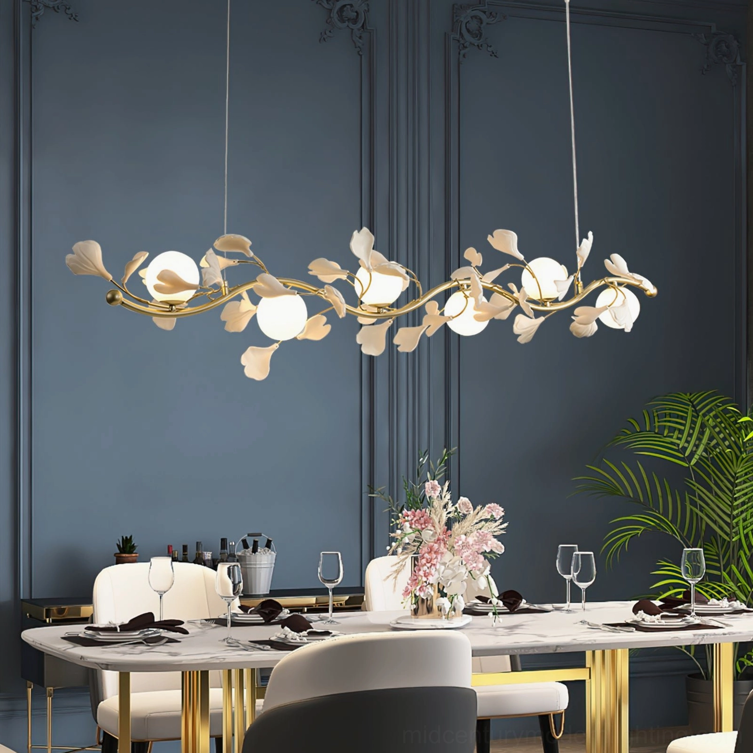Ginkko Glass Chandelier installed in luxury formal dining room above gold dining set with dark blue accent walls