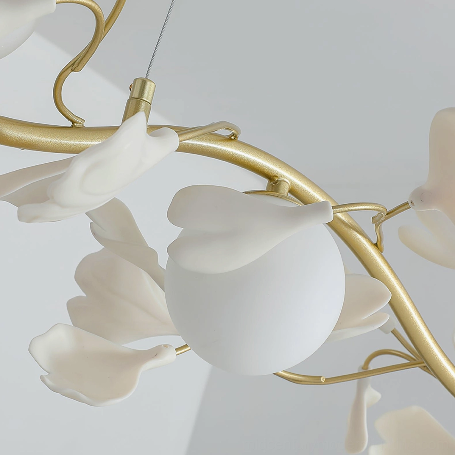 Ginkko Glass Chandelier gold brass and white ceramic composition suspended over dining surface