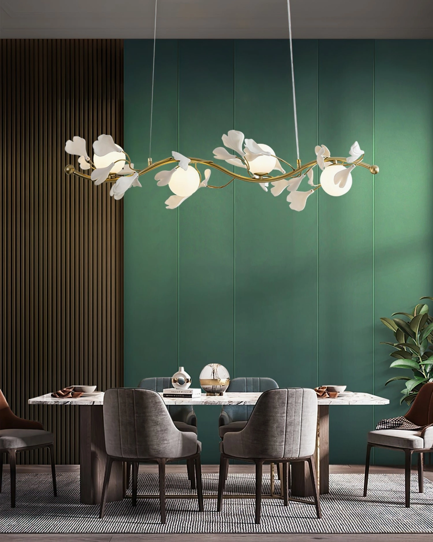 Ginkko Glass Chandelier linear brass fixture above dining table in modern room with green accent wall