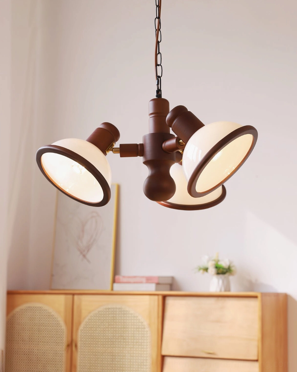 Girona Mia 3-head chandelier installed in mid-century modern living room with wooden sideboard and minimalist décor