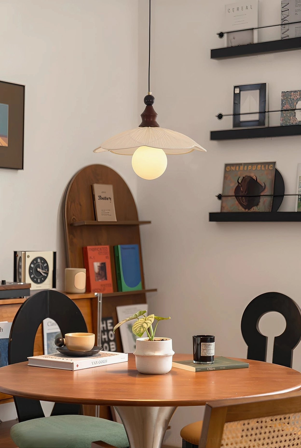 Giselle pendant light above vintage dining table - mid-century design with wooden chairs and wall shelving