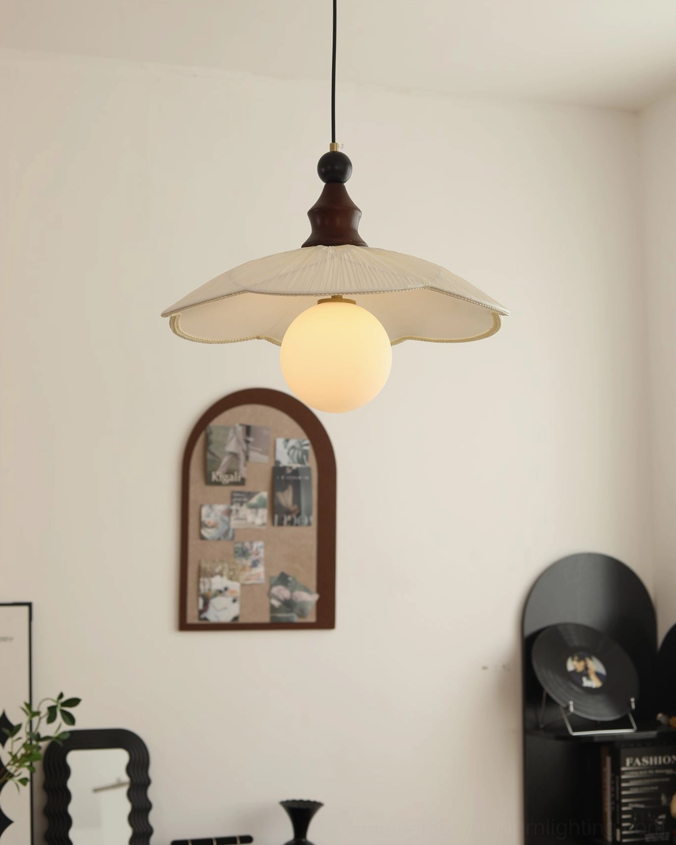 Giselle pendant light in minimalist wall corner - arched photo frame and black display shelf arrangement