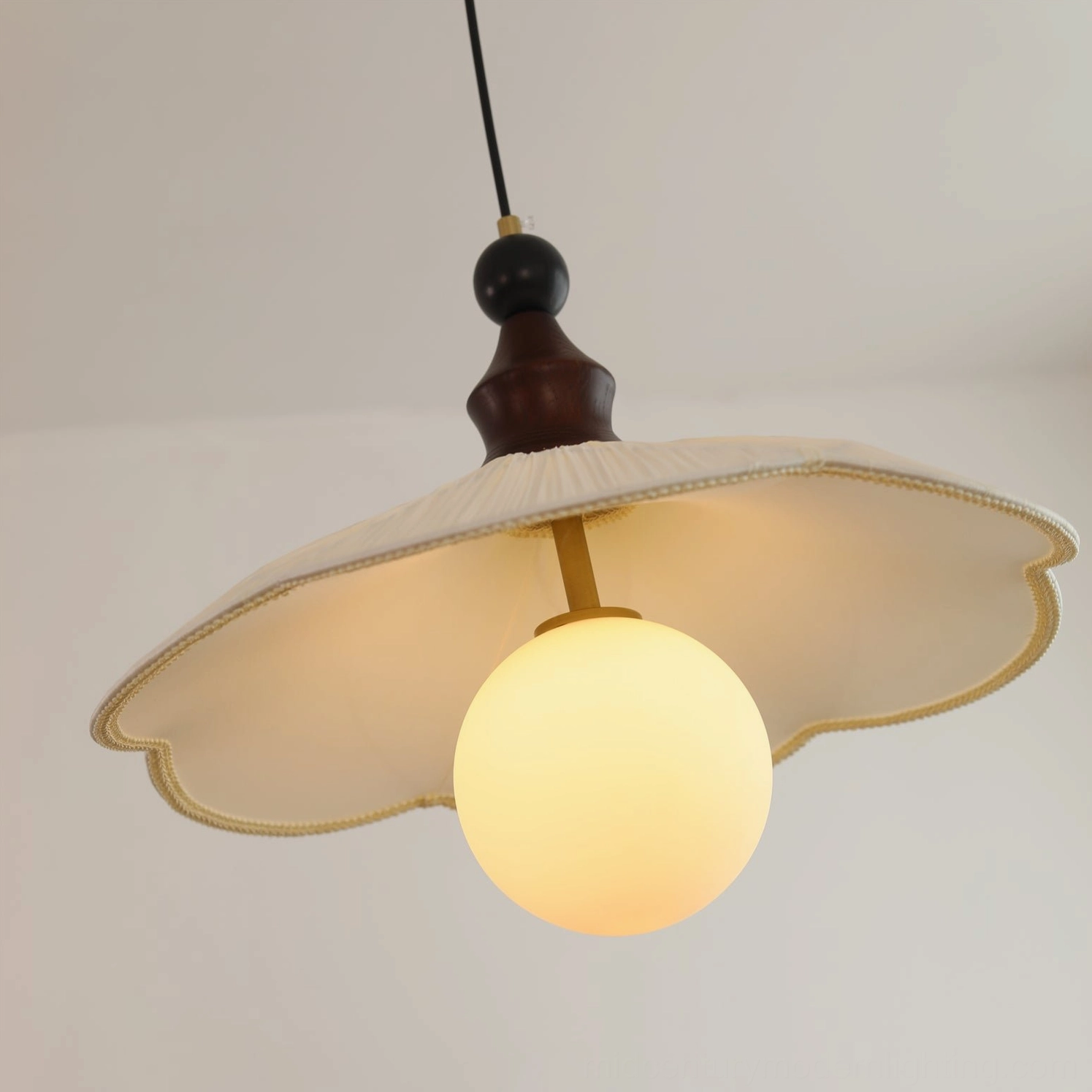 Giselle mid-century modern pendant light - close-up detail of pleated fabric shade and brass hardware