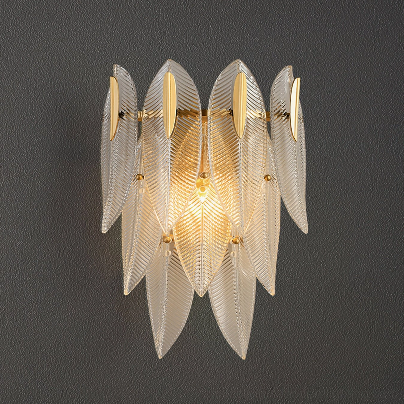 Giulia brass wall sconce with ribbed glass showing material contrast between metal and textured glass