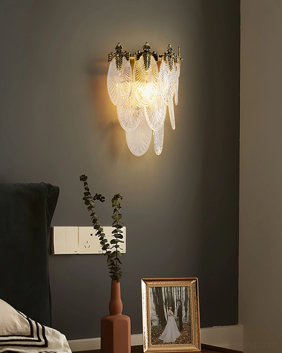 Giulia brass wall lamp creating dramatic accent lighting in contemporary luxury interior space