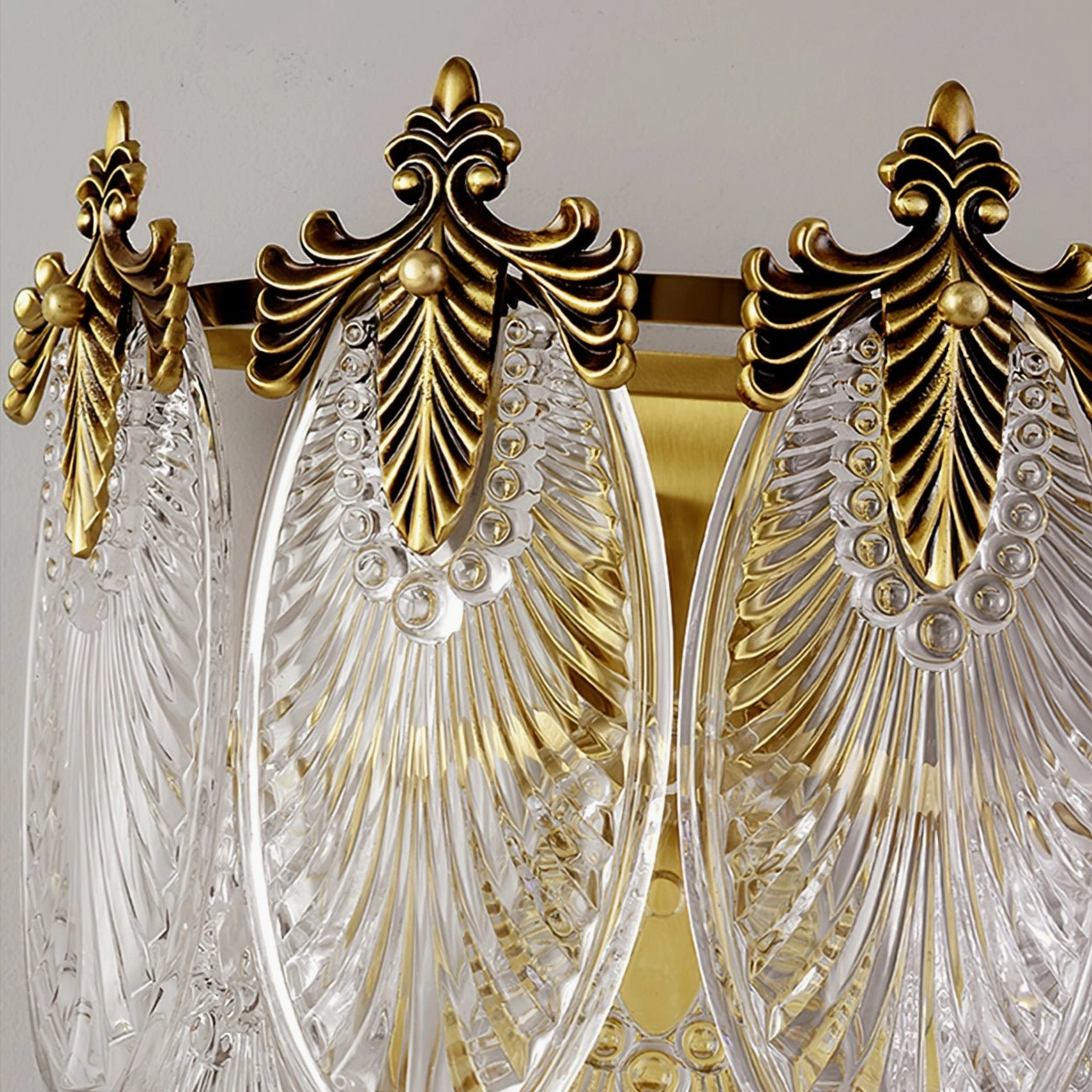 Giulia mid-century modern brass wall sconce creating sculptural light shadow effect on wall