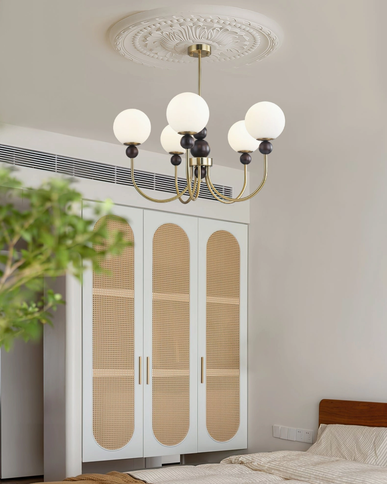 Contemporary glass pendant chandelier in Nordic-style bedroom with rattan wardrobe