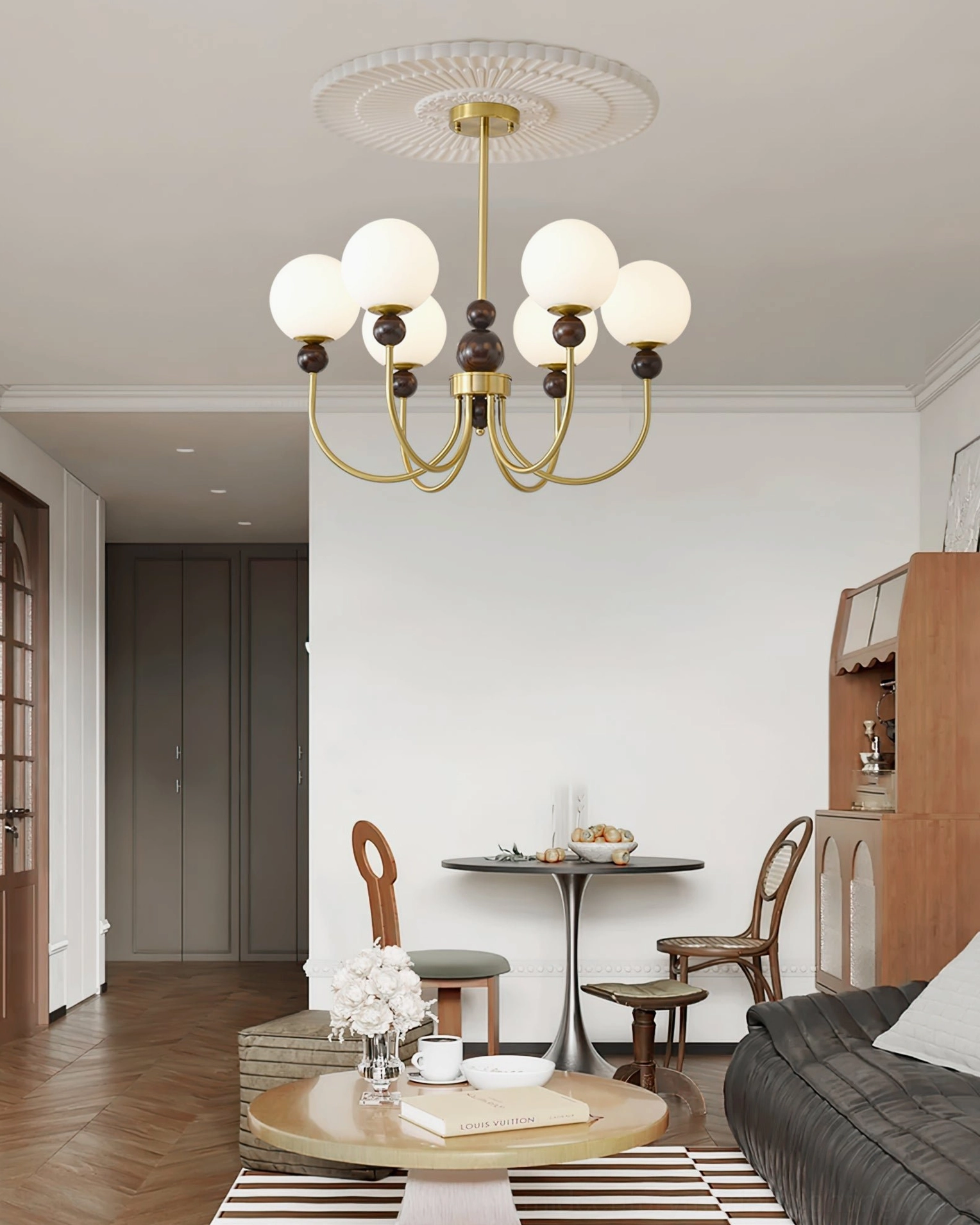 Glass pendant chandelier overhead view in open retro dining-living space with dining table and sofa