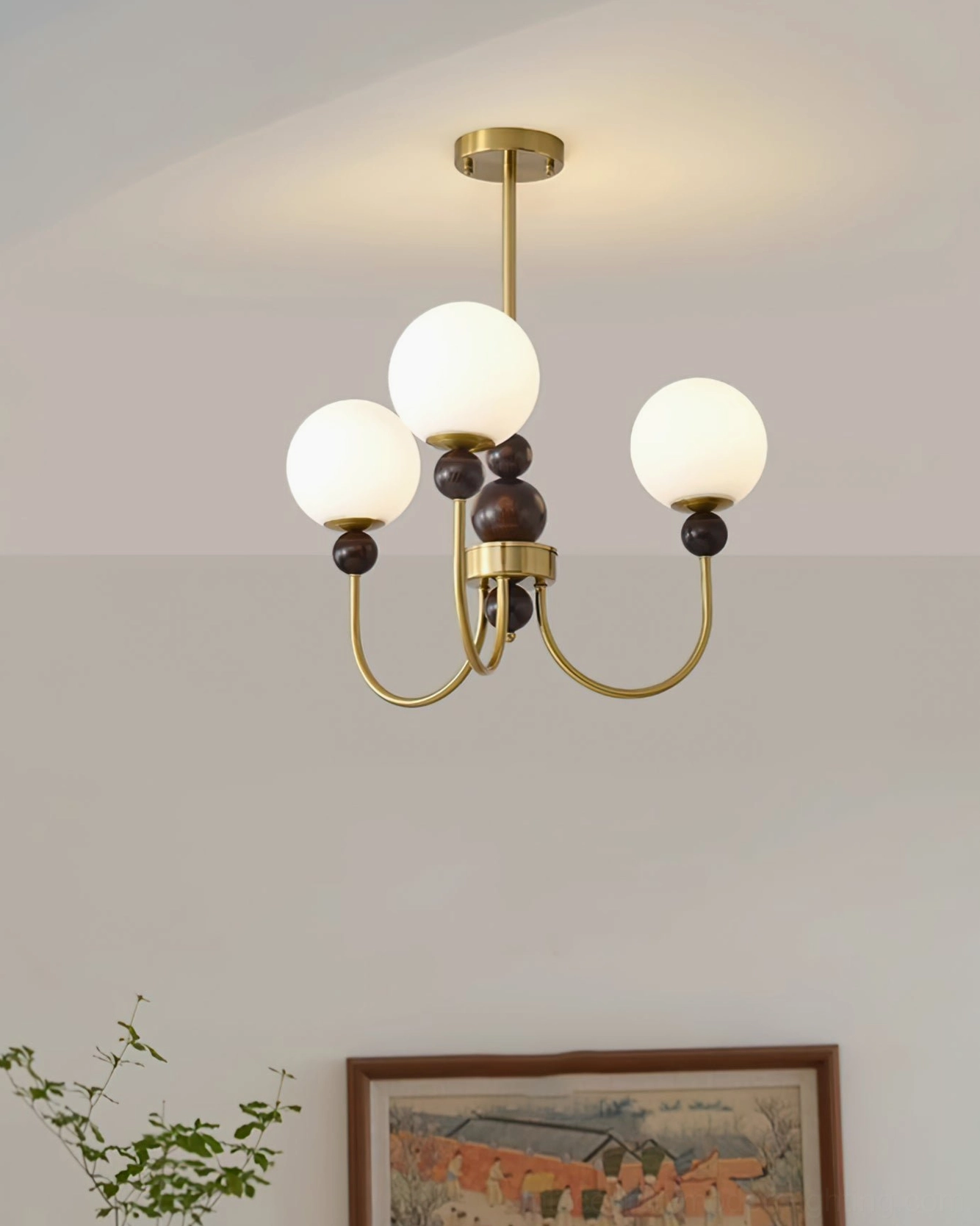 Contemporary glass pendant chandelier with warm metal frame and frosted glass spheres