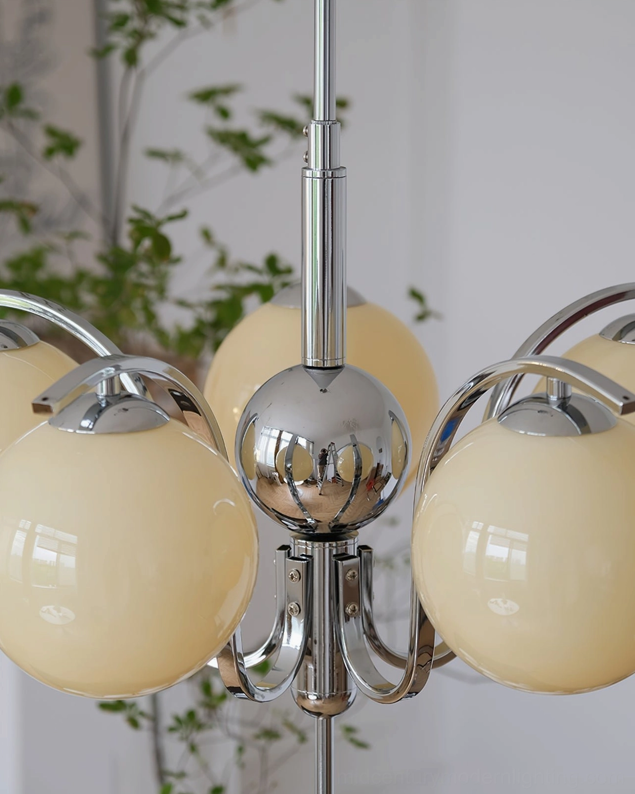 Close-up detail of 6-head creamy glass globe chandelier showing glossy thick glass and polished chrome hardware