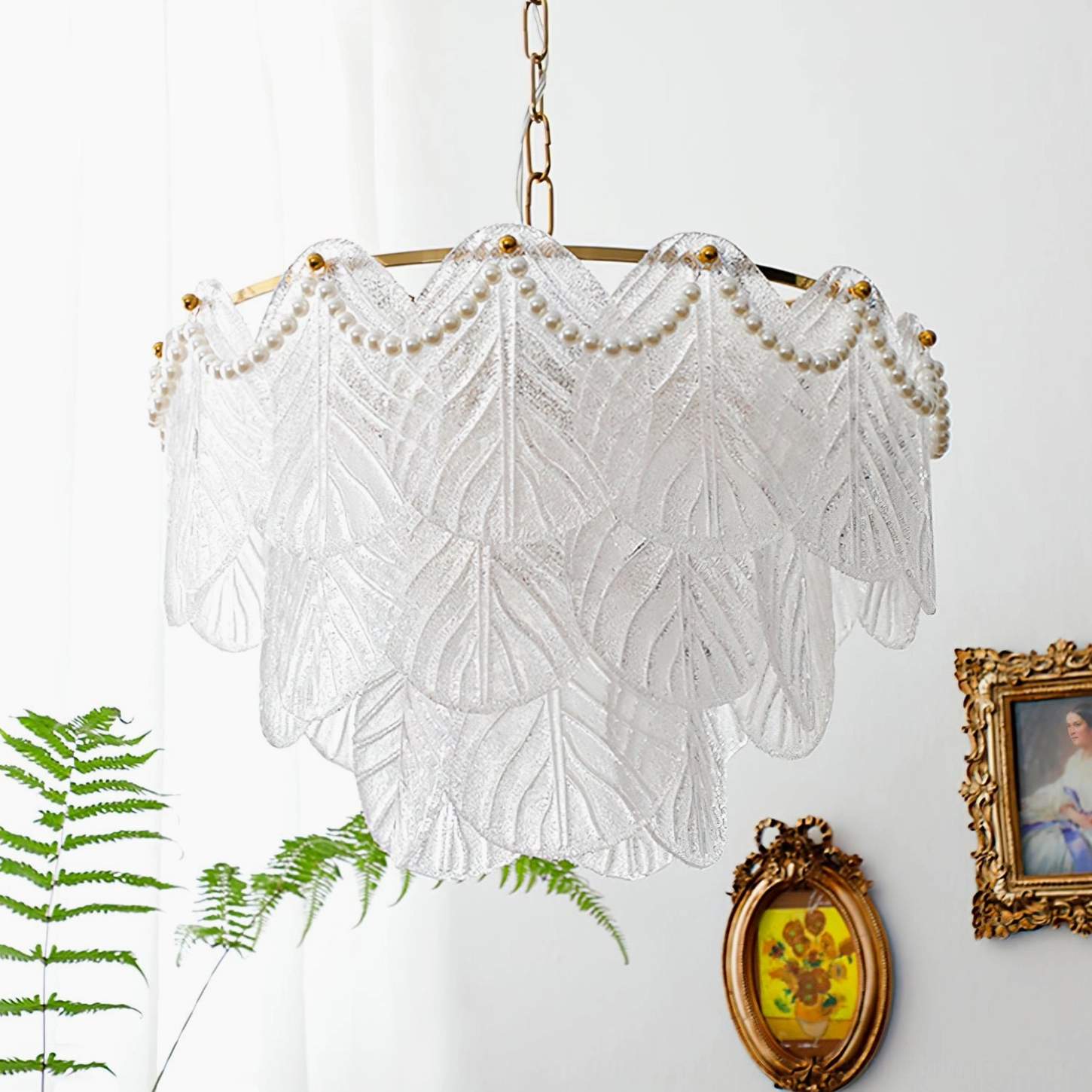Three-quarter close-up view of mid-century modern glass leaf pendant lamp with brass hardware against vintage interior wall, romantic botanical-inspired lighting fixture