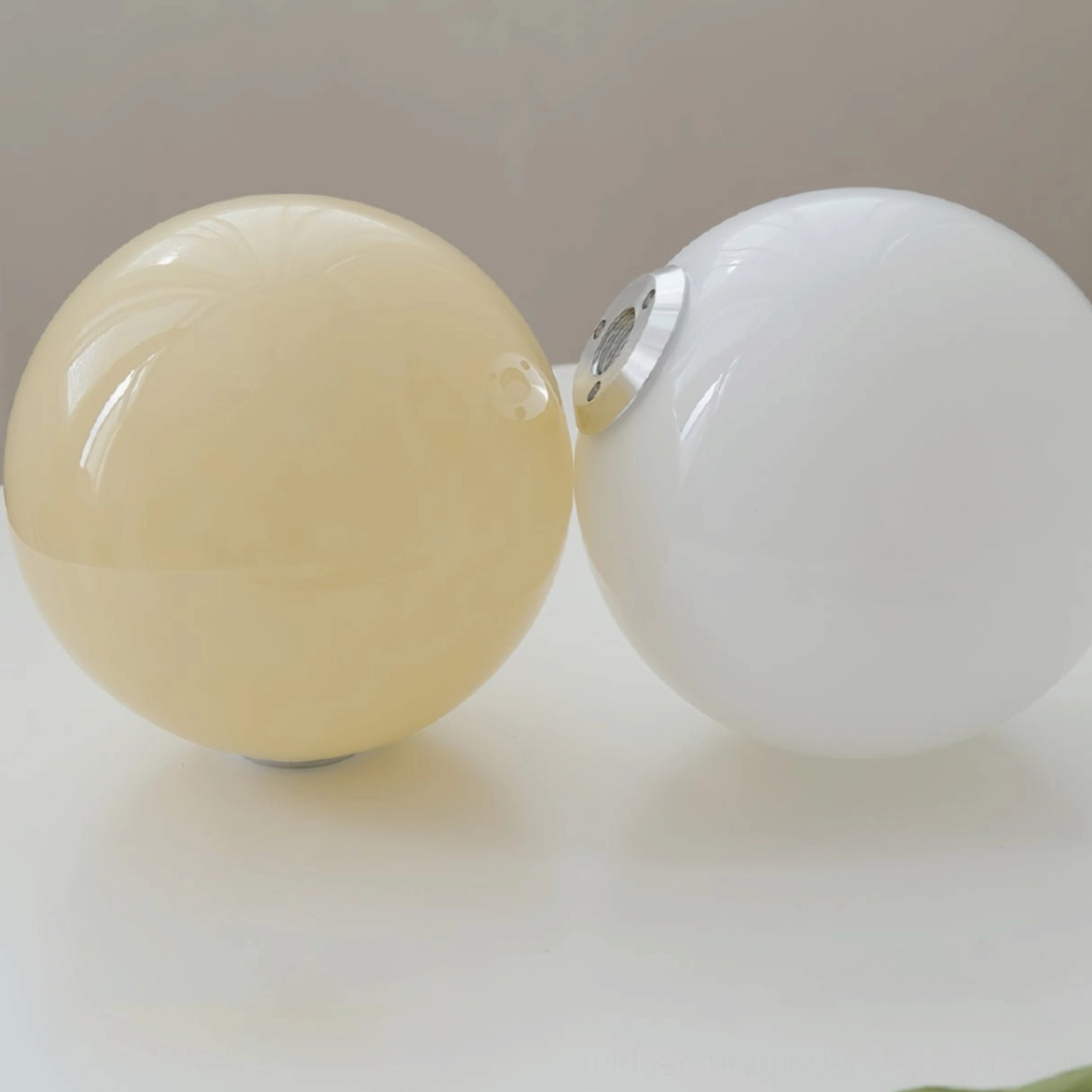 Modern glass sphere chandelier installed ceiling mount with suspension rod connection detail