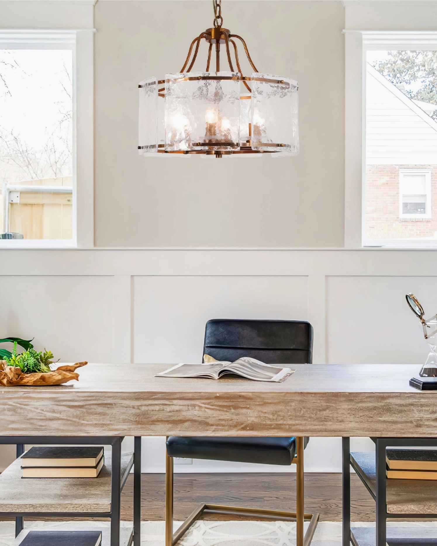 Glenn Round Chandelier in minimalist home office - warm brass fixture above wood furniture