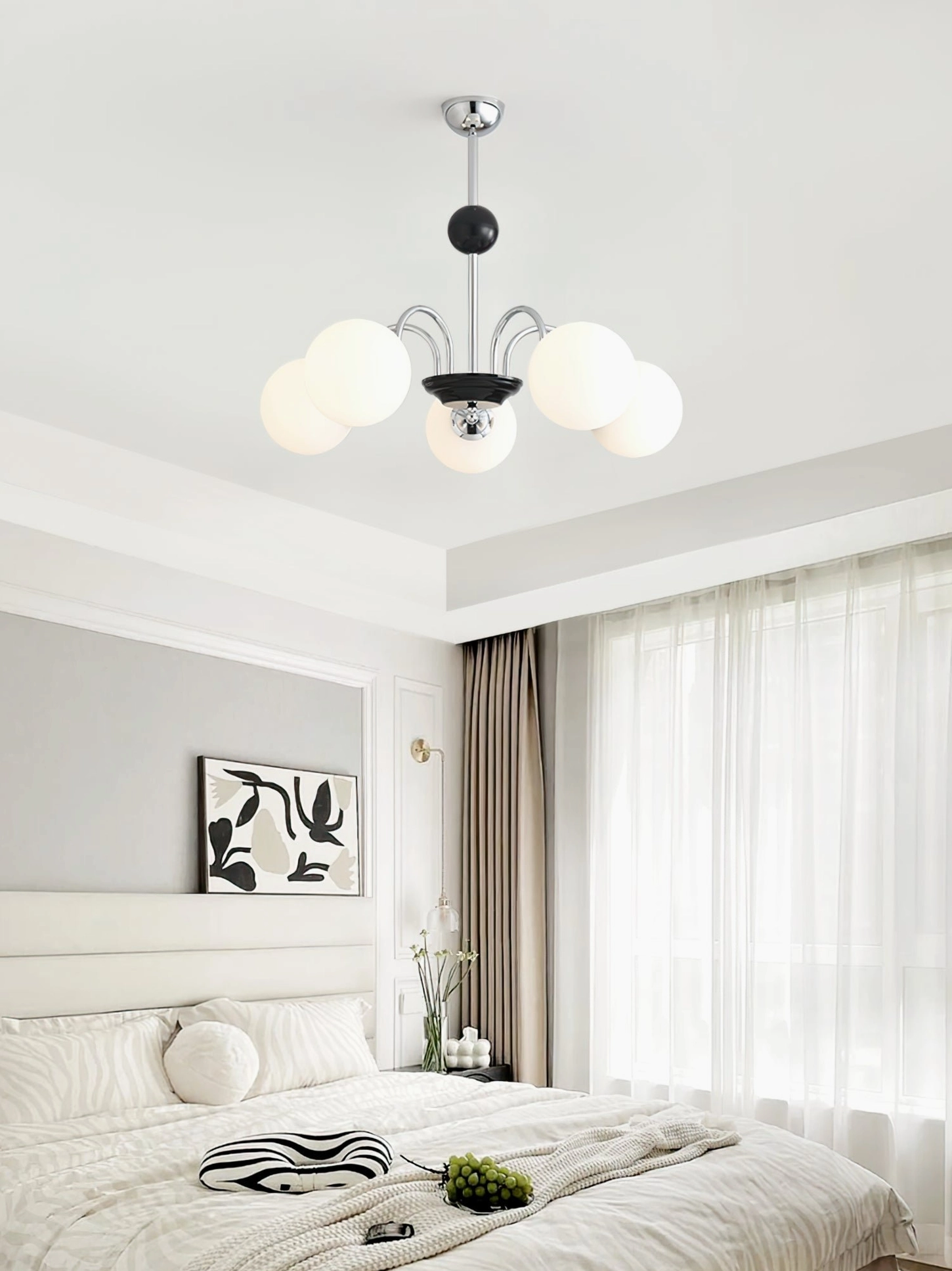 Multi-globe chandelier with silver-black hardware and frosted white glass in minimalist bedroom interior