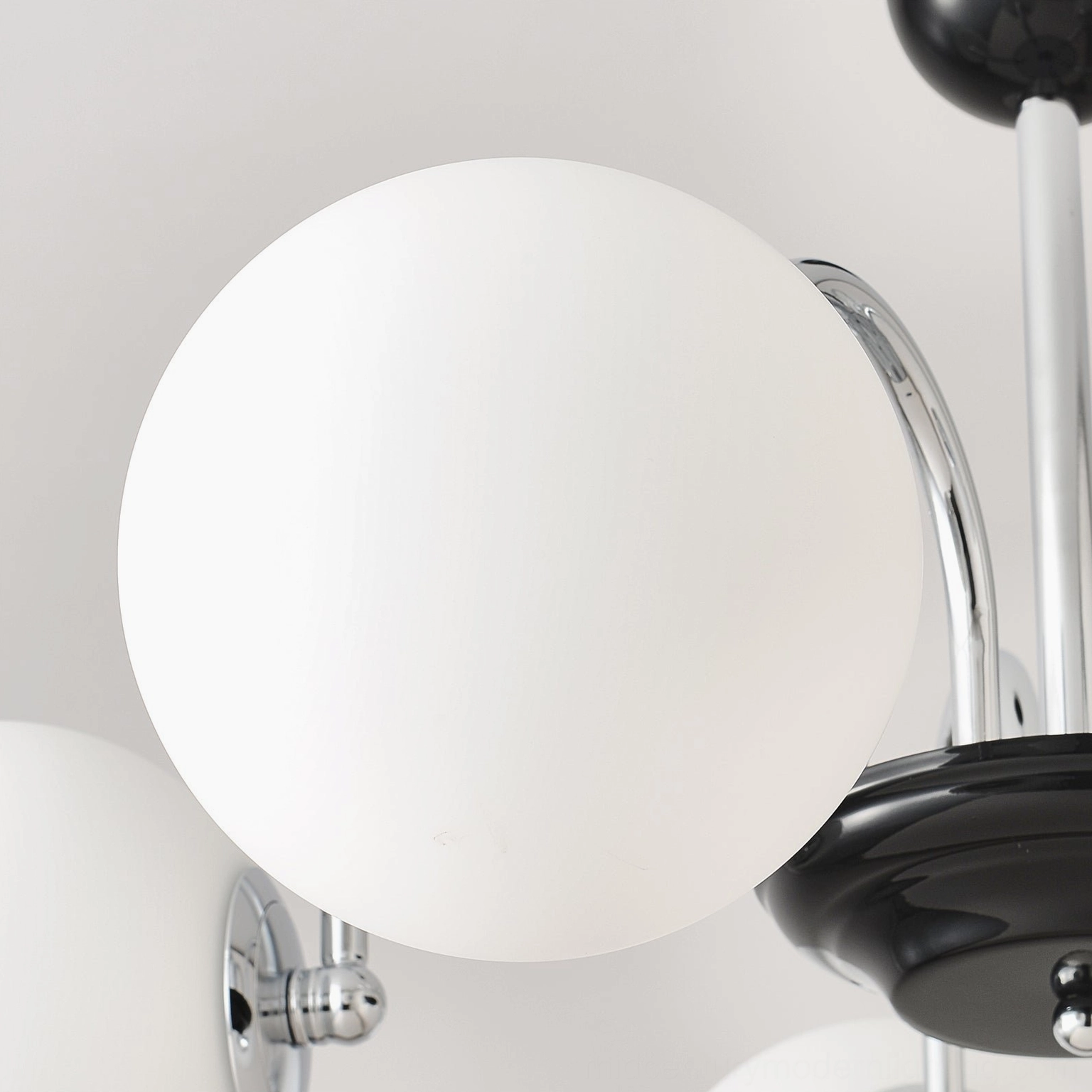 Globe chandelier showing detailed craftsmanship of frosted glass shades and metal framework
