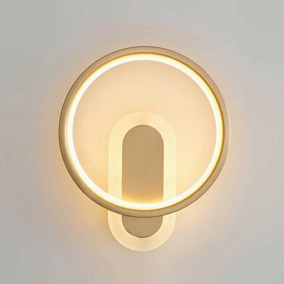 Gold brass round wall sconce installed in contemporary home interior with modern furnishings