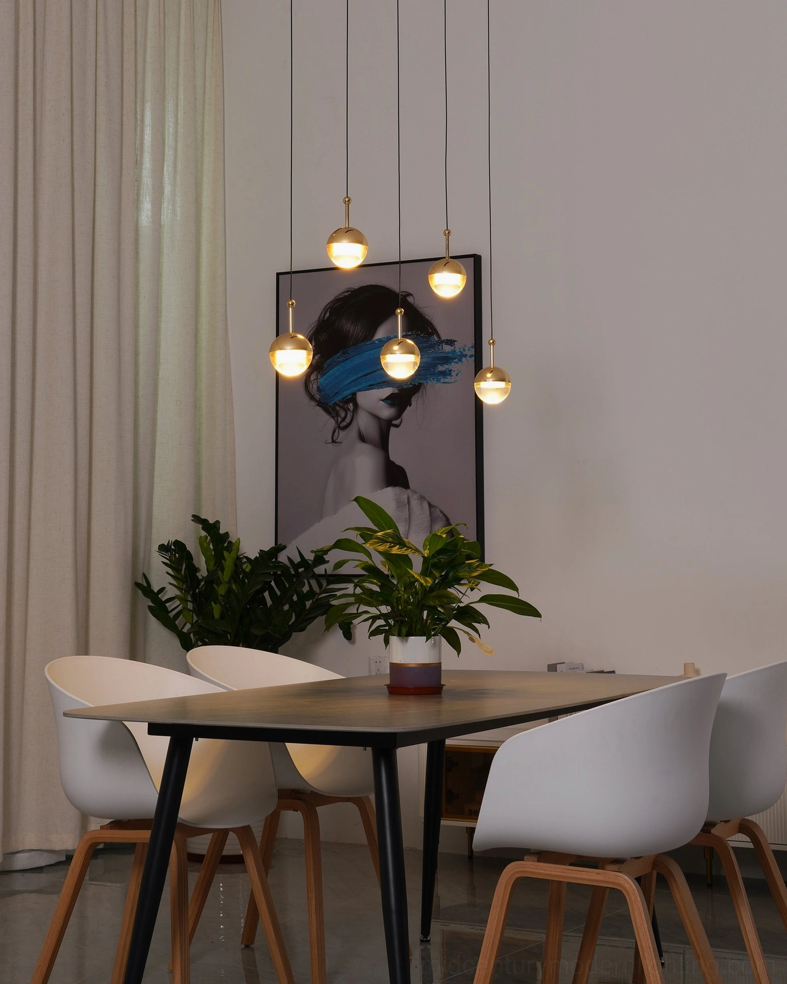 Gold spherical pendant chandelier set bright modern dining room eye-level view warm-toned lighting