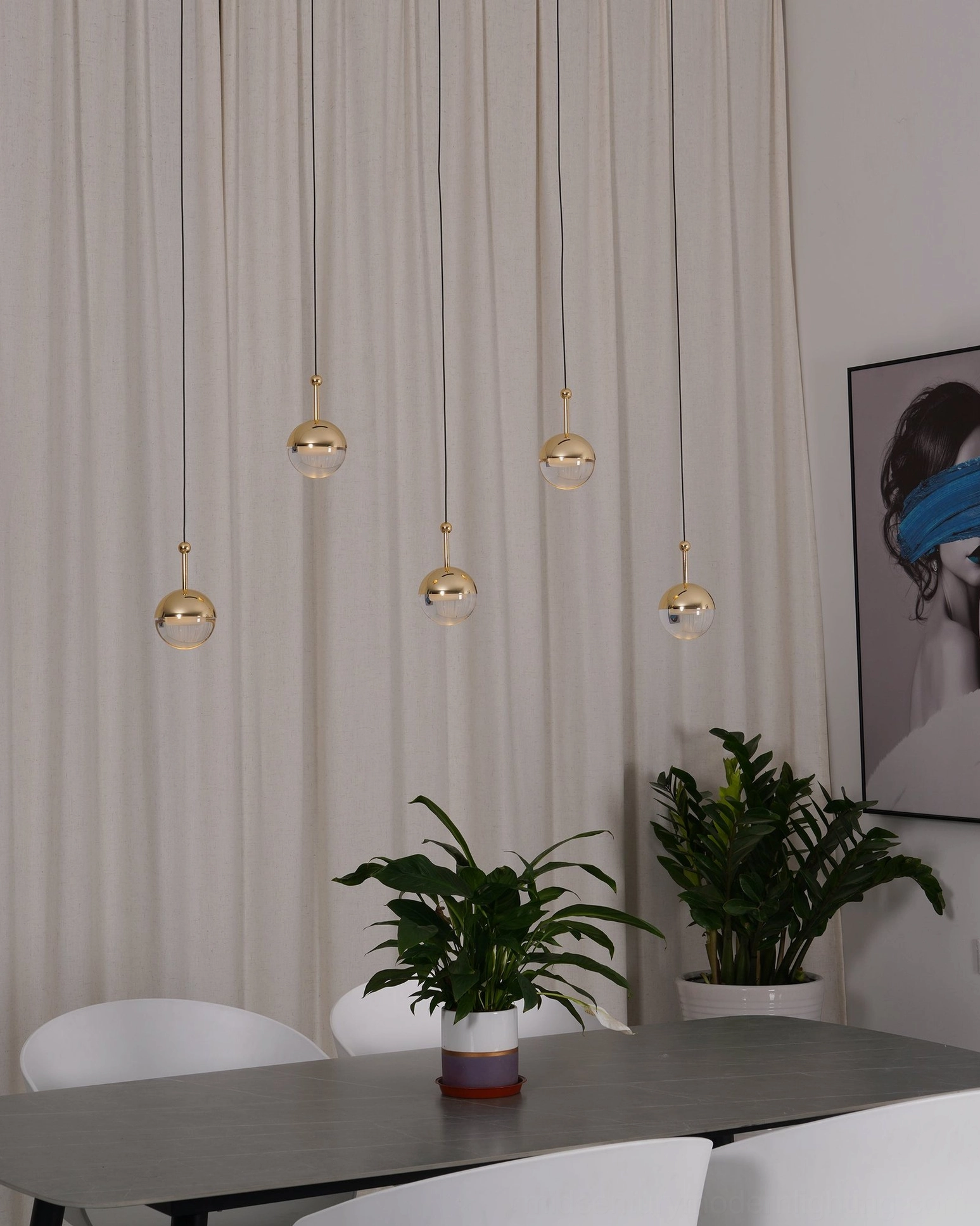 Gold spherical pendant light set wide dining area with sheer curtains modern minimalist warm lighting