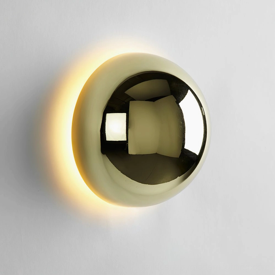 Gold finish sphere wall sconce creating warm atmospheric home interior lighting
