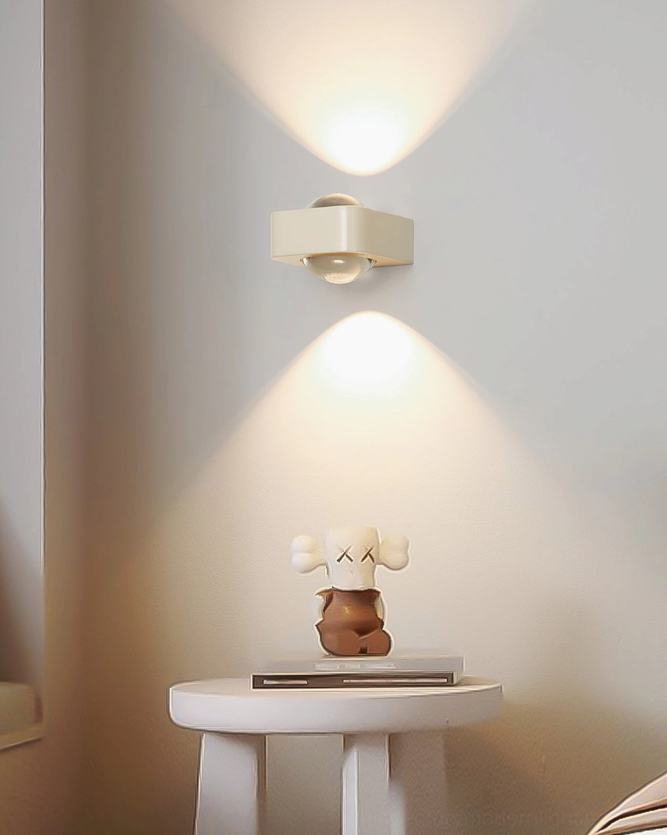 Grace modern wall sconce in cream installed above bedroom side table