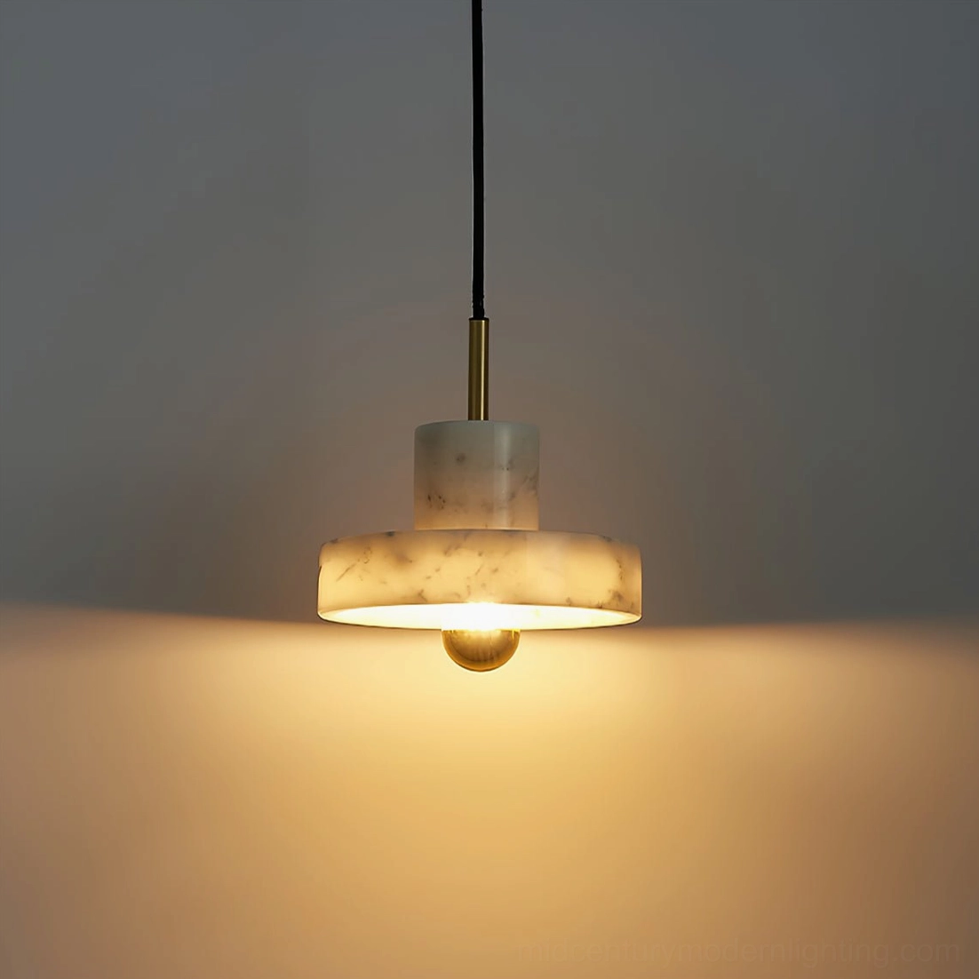 Green marble pendant lamp showing unique natural stone patterns and warm brass fixture