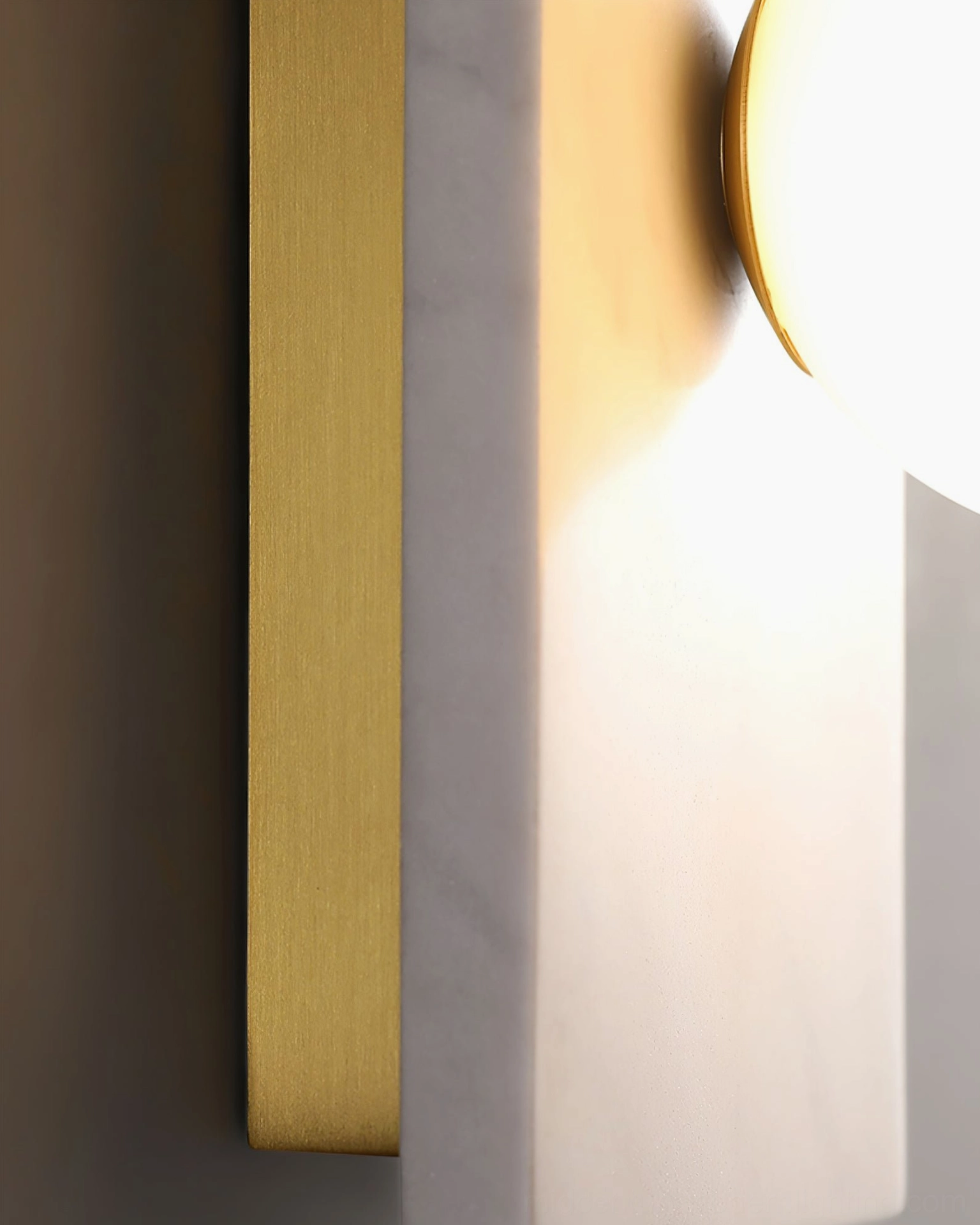 Green marble Lan wall sconce architectural detail highlighting natural stone base and polished brass elements