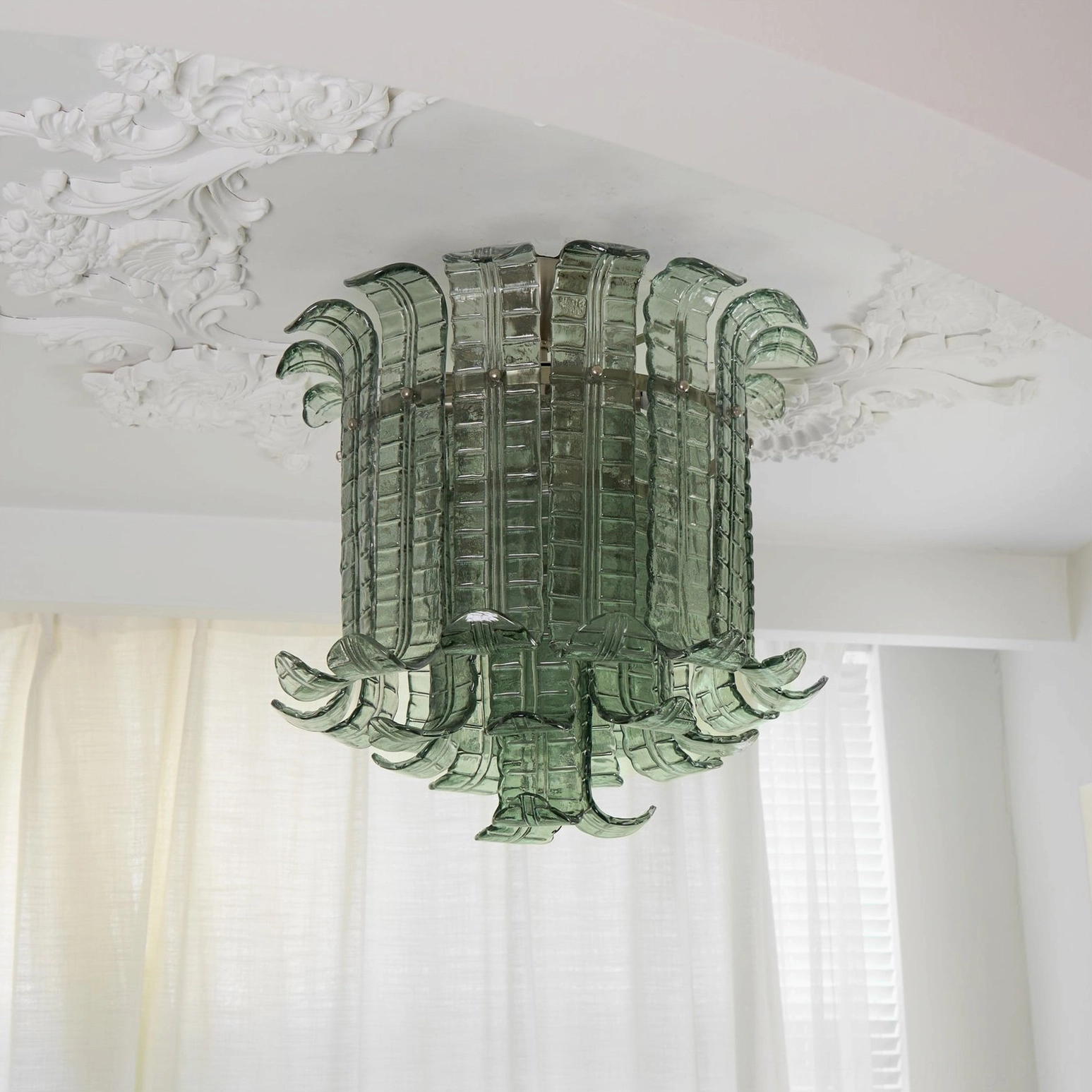 Green glass leaf ceiling lamp installed in bedroom, warm ambient lighting from textured panels, vintage luxury aesthetic