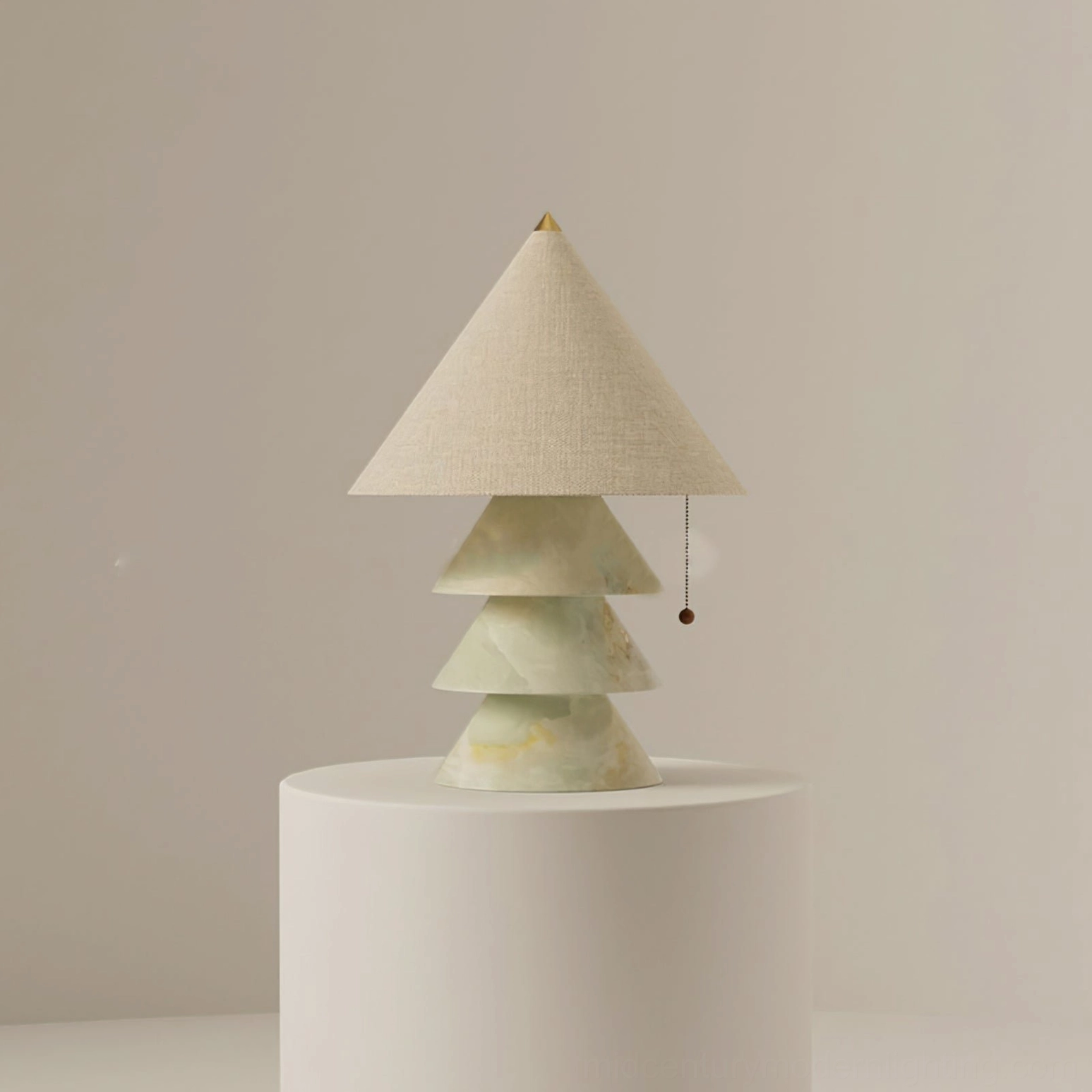 Light green jade marble pyramid table lamp displayed on pedestal with warm neutral backdrop