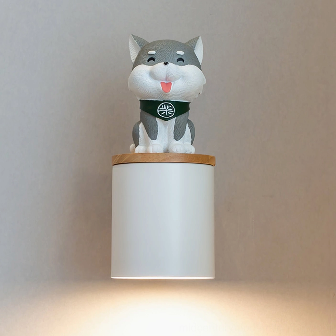 Grey Shiba Inu wall lamp front view with warm downward light glow on blank wall