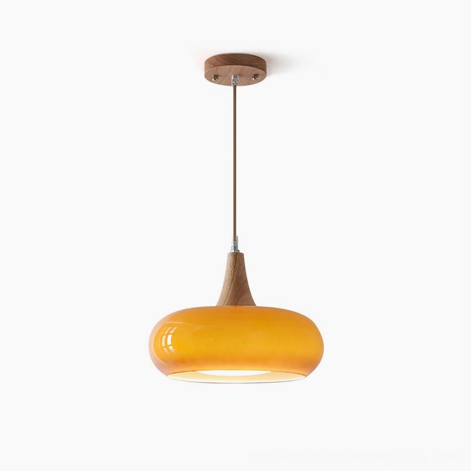 Hailie mid-century modern pendant lamp with warm amber glass shade and walnut wood frame, studio front view