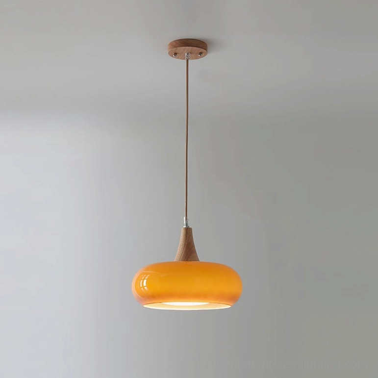 Single head Hailie pendant lamp in orange amber finish with natural wood accents, overhead studio angle