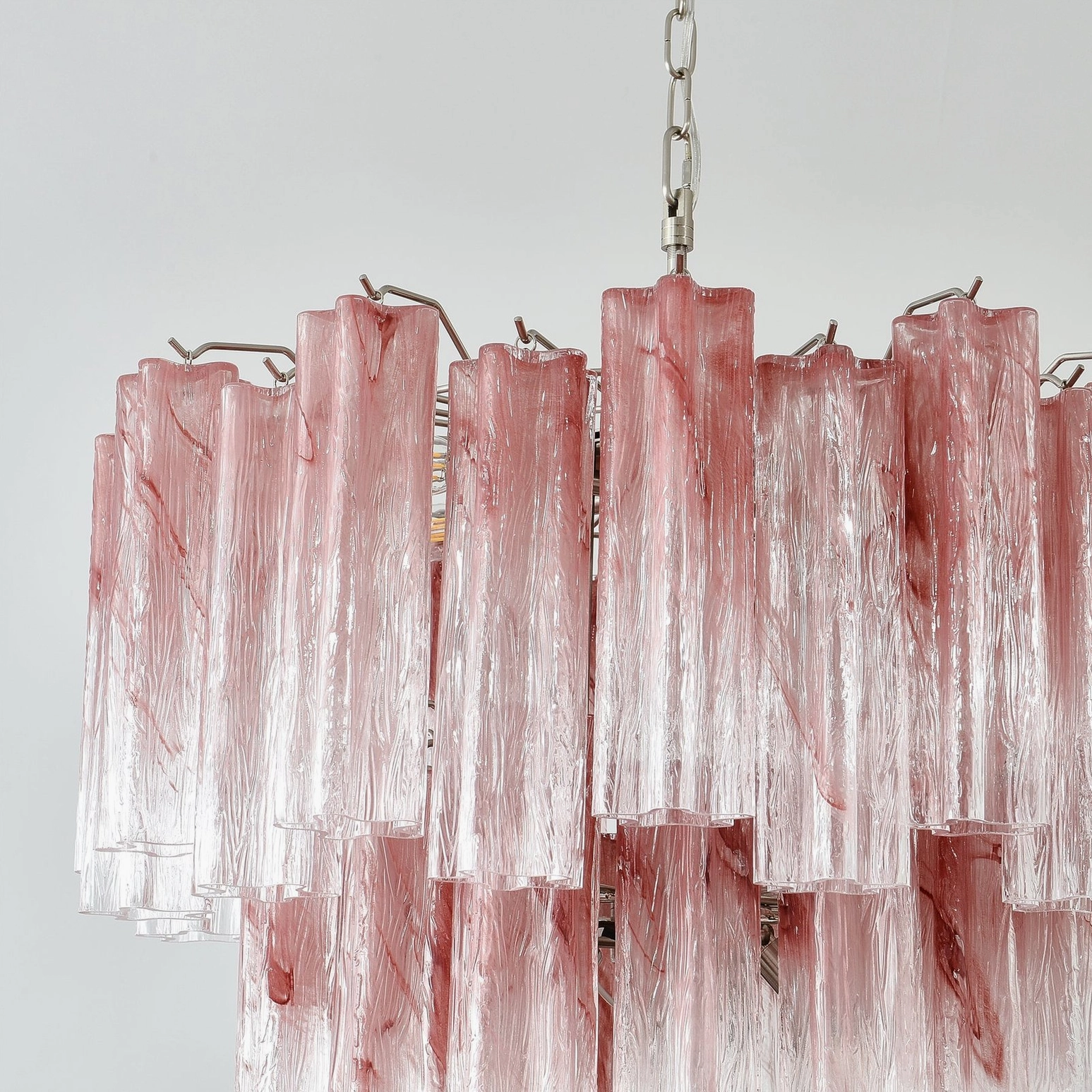 Detailed shot of pink Murano tube chandelier showing hand-blown glass variations and artisanal quality
