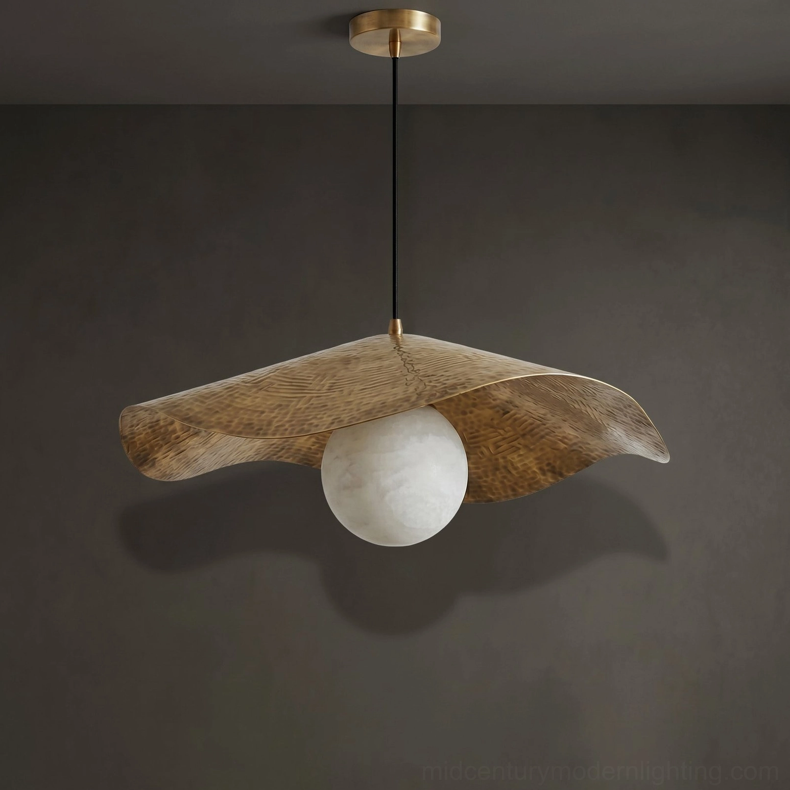 Hand-crafted alabaster pendant light showing organic brass hammered shade design and natural stone globe illumination