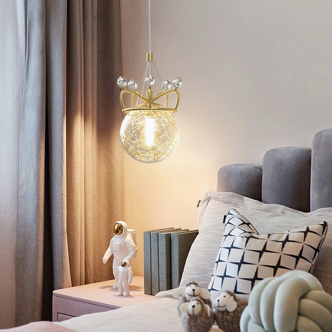 Gold crown pendant light in modern bedroom with grey headboard and contemporary decor