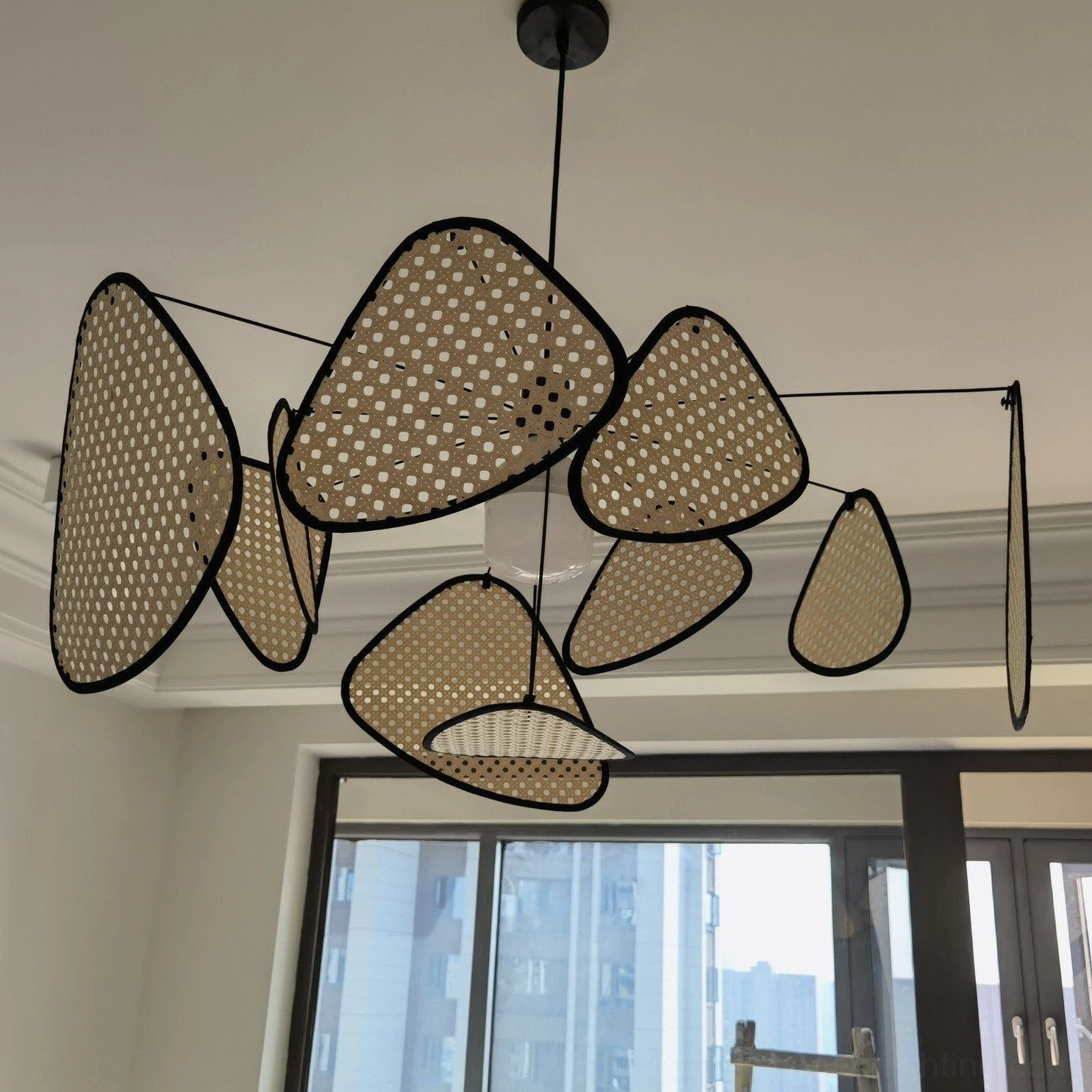 Handcrafted rattan pendant light detail, perforated shade construction and light diffusion pattern