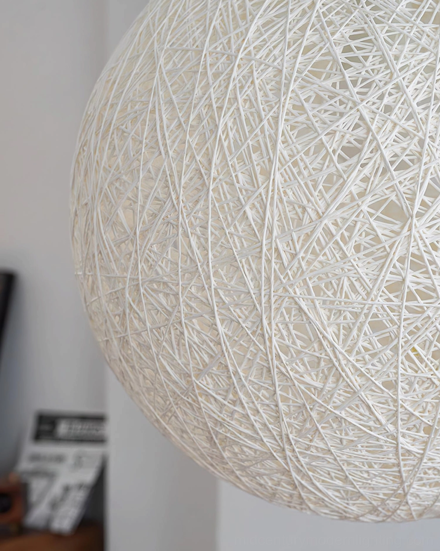 Wicker globe lamp close-up intricate hand-woven rattan detail craftsmanship