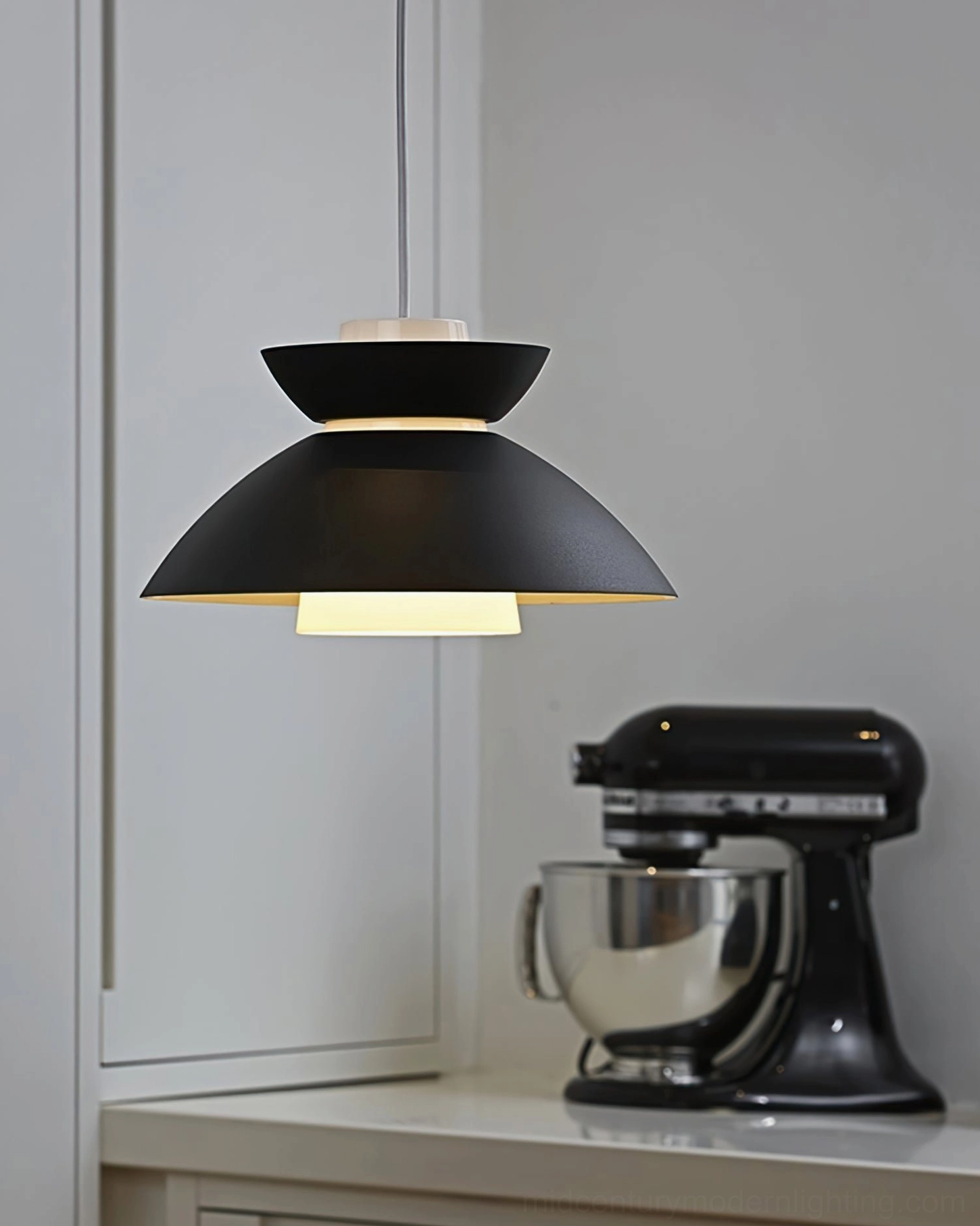 Single Hannes contemporary pendant lamp hanging above kitchen counter with stand mixer below, eye-level view