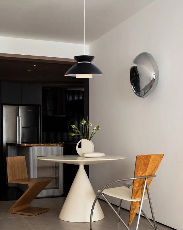 Hannes pendant lamp installed above round dining table in modern minimalist dining area with contemporary decor