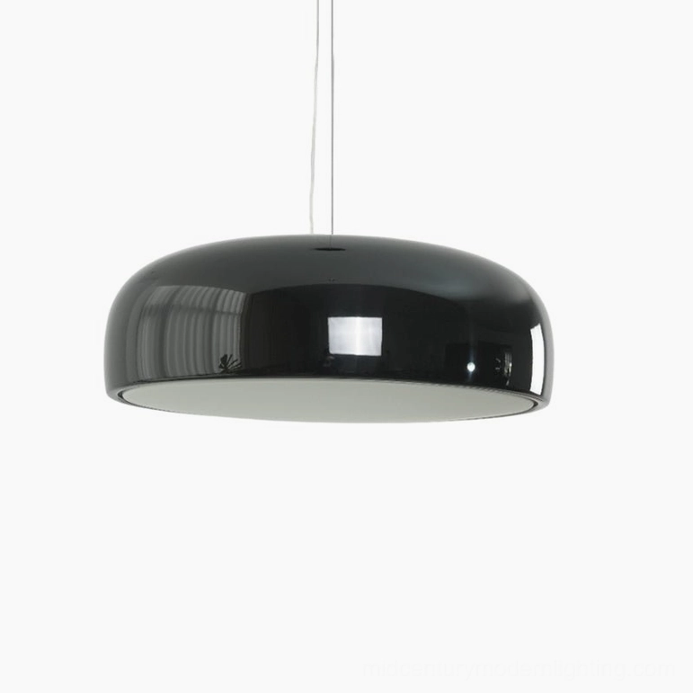 Black Harper pendant light installed above dining surface, sophisticated modern dome design in matte black aluminum finish