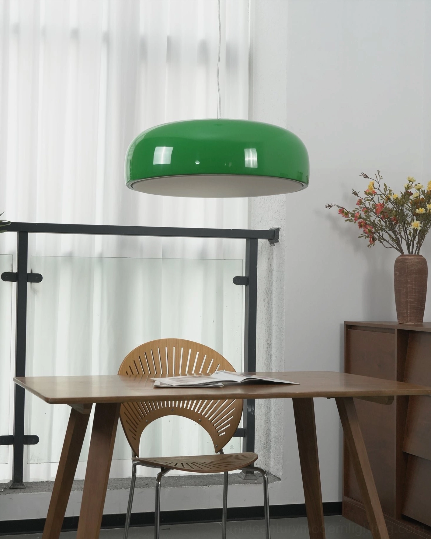 Green Harper pendant light above wooden workspace desk in Nordic home office, mid-century modern aluminum fixture with contemporary workspace styling