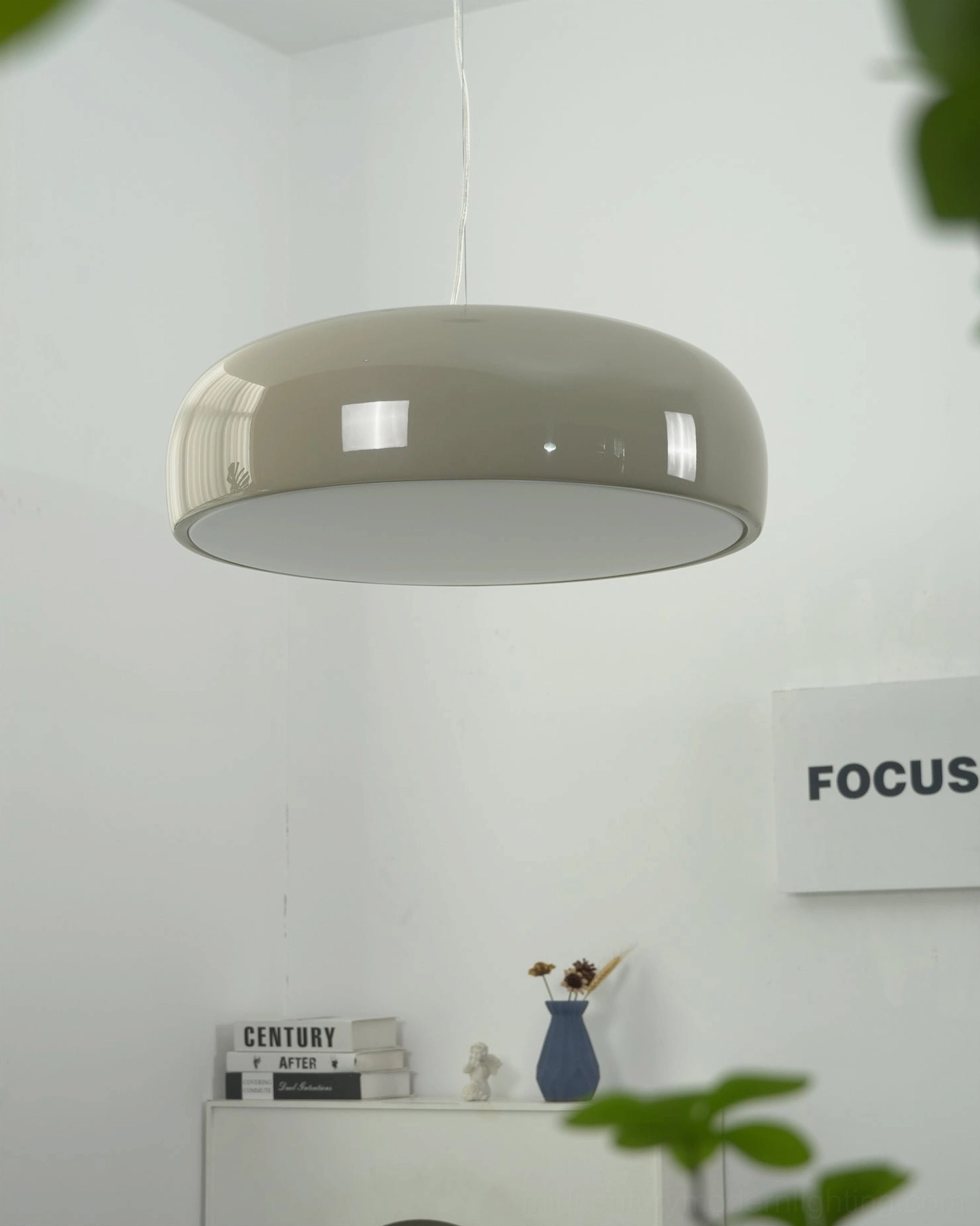 Taupe grey Harper pendant light in minimalist home display corner, neutral tone dome shade with eye-level partial architectural view