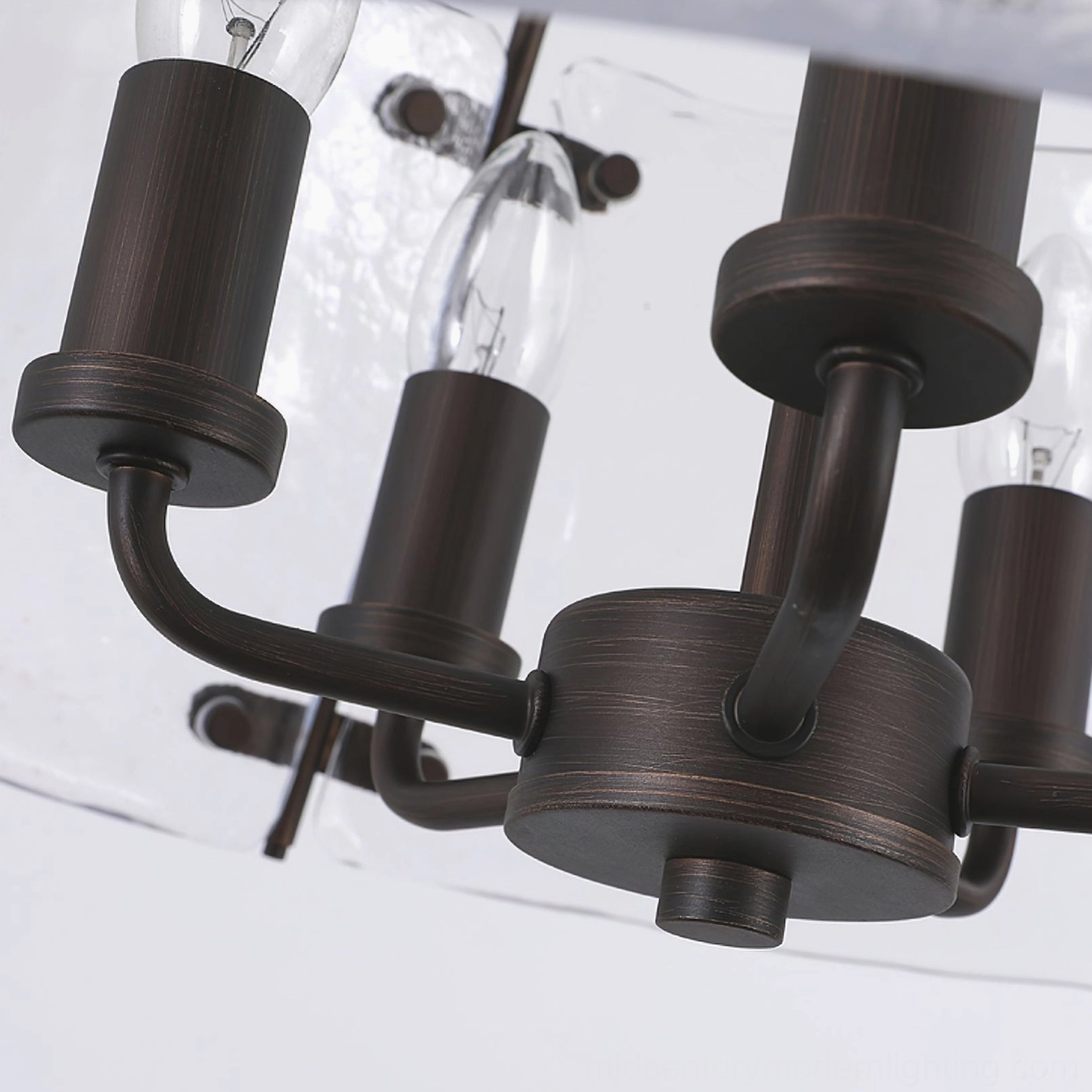 Harrow pendant light fixture showing exposed E14 candle bulb sockets and brushed bronze metalwork