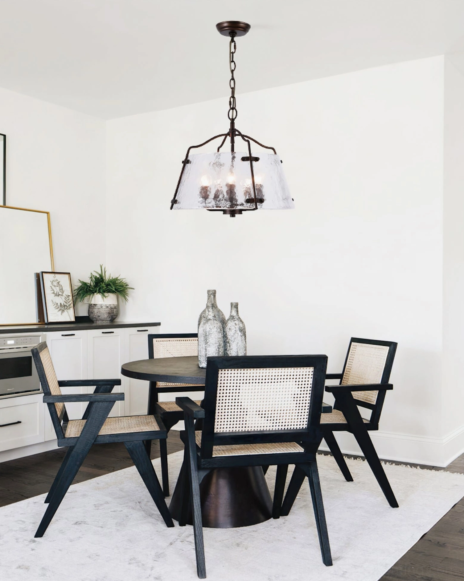Harrow pendant chandelier installed above dining table in contemporary dining room setting