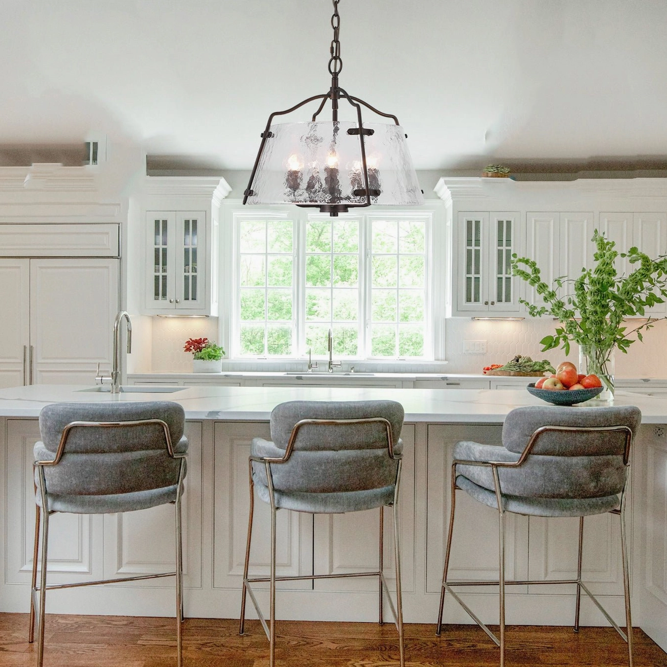 Harrow industrial chandelier suspended above kitchen island in warm rustic modern home