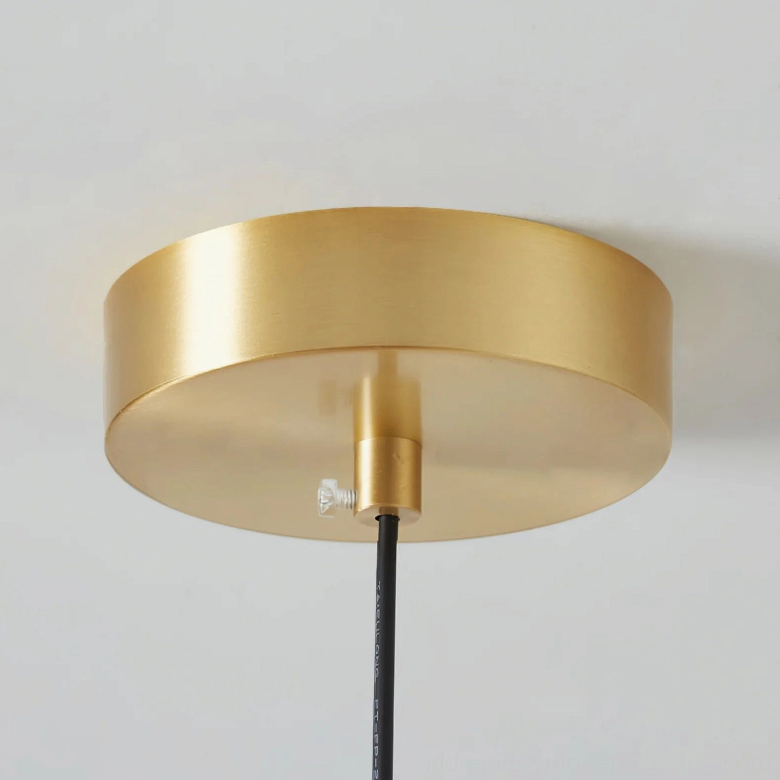 Harvey pendant ceiling light fixture design detail, mid-century modern aesthetic with brass metal and amber glass
