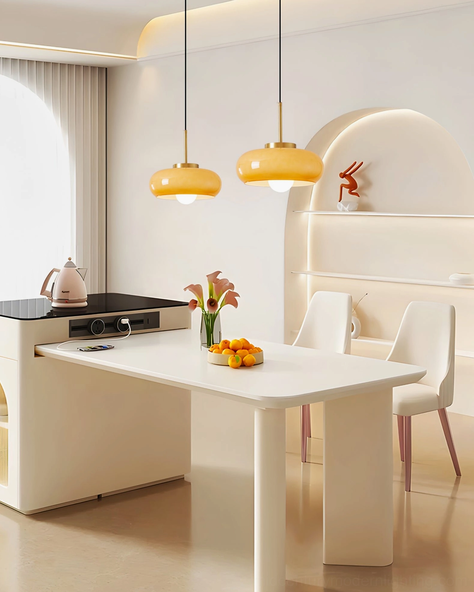 Two Harvey pendant lamps hanging over kitchen island in modern creamy kitchen, warm neutral home decor styling