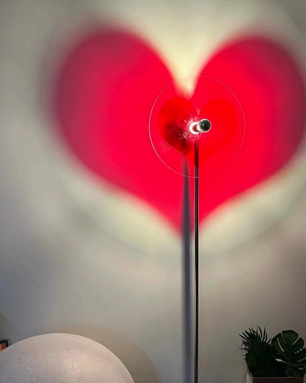 Red heart floor lamp with polished chrome finish showcasing design detail and craftsmanship